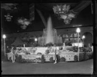 Two women stand in front of the Los Angeles County display at the Los Angeles County Fair, Pomona, 1932