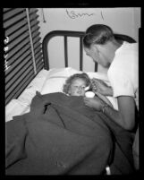 Diane Carol Harris is treated for broken arm at Van Nuys Receiving Hospital after surviving plane crash, 1949