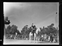 Woman on horseback waving to the crowd at the Tournament of Roses Parade, Pasadena, 1935