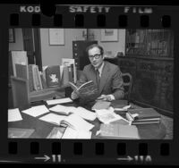 Librarian Daniel Woodward seated in office at Huntington Library in San Marino, Calif., 1975