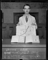 Ronald Mansbridge shows some rare books on display at the Los Angeles Public Library, Los Angeles, 1935