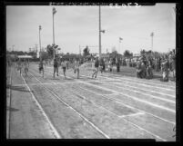 Collegiate 100-yard dash athletes cross finish line in Long Beach Relays, Calif., 1949