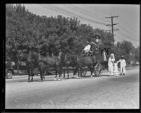 Roy Steel, Captain E. D. Ayres, Thomas Workman Temple, Princessita Charlene Lugo, Queen Gabriela Quiroz, Princessita Dorothy Martinez and an unidentified man pose with a stage coach, San Gabriel, 1935