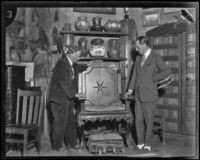 Charles F. Lummis shows the Duke of Alba an antique chair, Los Angeles, 1924