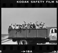 El Salvadorian migrant workers display melon harvest from truck