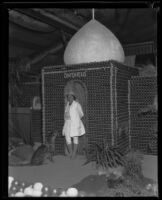 Olga Celeste stands in front of the Ontario booth at the Los Angeles County Fair along with her leopard, Pomona, 1929