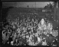 Santa Claus (Edward Shaffer) hands out Christmas presents to children at the Wilshire Council P.T.A.'s Christmas party, Los Angeles, 1935