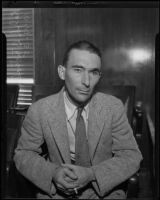 Interior decorator and check forger Ralph B. McMahon sits in courtroom, Los Angeles, 1935