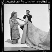 Cartoonist Frank Interlandi with model wearing cartoon dress, Calif., 1967