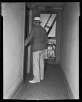 Detective Sergeant Sibley standing at the door leading to Gladys G. Fair's apartment, Long Beach, 1935