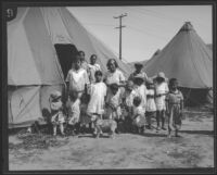 Women and children stand outside a tent after the flood resulting from the failure of the Saint Francis Dam, Santa Clara River Valley (Calif.), 1928