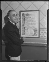 Harbor Dept. general manager Arthur Eldridge with framed document commemorating his appointment, Los Angeles, 1934