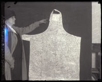 Frankie Bailey pointing to her autographed apron, Los Angeles, 1925