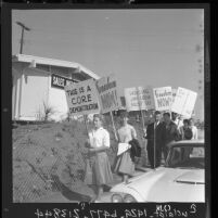 Supporters of the Congress of Racial Equality carry anti-segregation placards in Monterey Park, Calif., 1962