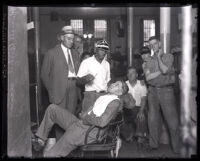 Convicted murderer, Russell Beitzel getting a shave in prison, San Quentin, 1928