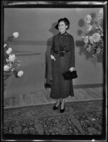 Woman models a coat and hat at Times' fashion show, Los Angeles, 1935