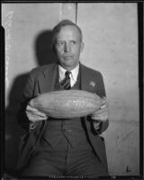 Roland C. Casad advertises the Los Angeles Times with a carved gourd, Los Angeles, 1925