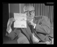 Deputy District Attorney J. Miller Leavy holding a police document regarding Barbara Graham's murder of Mabel Monahan, Los Angeles, 1959