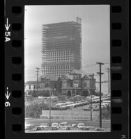 Victorian houses on Bunker Hill with steel frame of 42-story Union Bank building rising behind them, Los Angeles, Calif., 1966