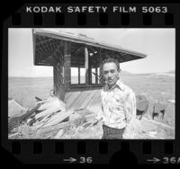 Former Tule Lake internee, Shinyu Yamagata besides remains of camp watchtower, Calif., 1979