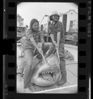 Jay Langham and Hugh Innes-Brown displaying great white shark that was caught off Southern California Coast, 1976