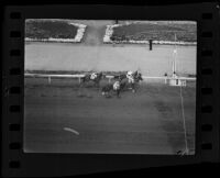 Horses approaching the finish line at Santa Anita Park on Christmas Day, Arcadia, 1935