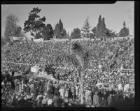 Grandstand spectators see the San Diego Exposition float at the Tournament of Roses Parade, Pasadena, 1936