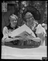 Alma Dube and Bertha Reinharth hold a hunk of Swiss cheese during the Old Folks Picnic, Los Angeles, 1935