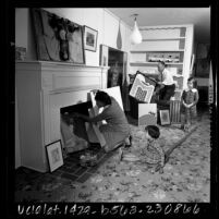 Art collector-Housewife Diana Zlotnick with family displaying part of her collection in North Hollywood, Calif., 1965