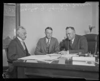 Martin G. Aguirre and Frank Dewar seated at a desk, Los Angeles, 1920-1929