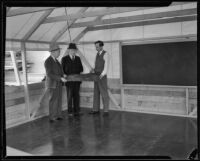 Three men transform a tent into a classroom, Los Angeles, 1935