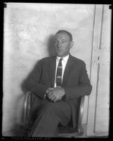 Harry Alpine, bootlegger and gambler sitting in chair in jail after being charged in shooting