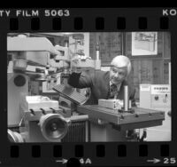 Select Machine Tool Co. President William F. Wolf displaying machine tools imported from China, 1980