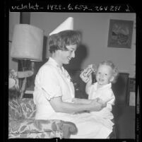 Major Lorraine R. Johnson of the Army Reserve Nurse Corps in uniform playing with her two-year-old son, 1970