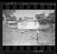 Boy playing in Hoyo Mara east side slum in Los Angeles, 1963