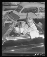 Barbara Payton in car outside of market on Sunset Blvd., 1951