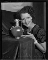 Geneva Shimp poses with ancient Egyptian glassware at the Natural History Museum, 1935