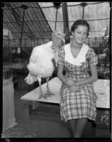 Carol Farrington and a turkey at the Los Angeles County Fair, Pomona, 1933