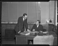 Robert L. Gordon, vice president of Bank of America, speaks with Jack Bugas after robbery, Los Angeles, 1936