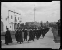 Loyola University students file into Carthay Circle Theatre for their graduation ceremony, Los Angeles, 1932