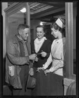 Oscar Tolford, Lillian Cook and Nurse Marguerite Forest go about typical hospital procedures at Los Angeles County General Hospital, Los Angeles, 1936