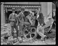 Three men next to automobile crushed by Long Beach Earthquake debris, southern California, 1933