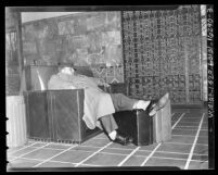 Man sleeping in chair in the waiting area of Los Angeles Union Station, 1939