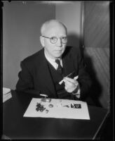 Jules Charbneau with pieces from his collection of miniatures, Los Angeles, 1934