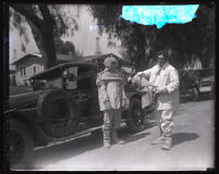 Two oil well firefighters in their asbestos suits at oil wells fire, Santa Fe Springs, 1928