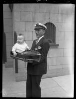 Kay Greer holding model boat and baby son Jack, Los Angeles Boat Show, Los Angeles, 1930