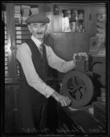 Tom Phelps cutting cigars in cigar shop, Los Angeles, 1935