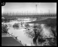 Pacific Electric Railway (or Red Car Trolley) bridge during rainstorm flooding in the Los Angeles River, Los Angeles, 1927