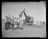 School superintendent Robert Ulrich and students study plans of Mojave Unified School District's first high school, Calif., 1954