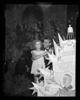 Shirley Temple and Eddie Cantor cutting President Franklin D. Roosevelt's birthday cake in Los Angeles, Calif., 1937